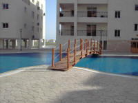 One bedroom flat on a small complex in Oroklini, near Larnaca in Cyprus for sale with sculpted shared swimming pool.