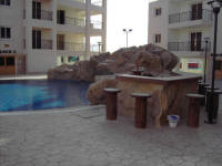 One bedroom flat on a small complex in Oroklini, near Larnaca in Cyprus for sale - built in pool bar.